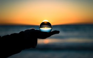 Preview wallpaper ball, hand, horizon, glass