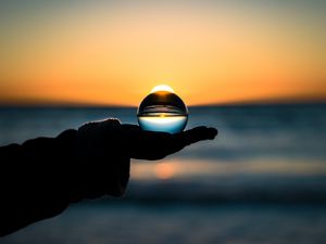 Preview wallpaper ball, hand, horizon, glass