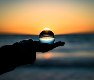 Preview wallpaper ball, hand, horizon, glass