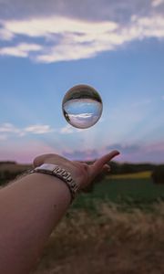 Preview wallpaper ball, hand, reflection, watch, sky