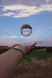 Preview wallpaper ball, hand, reflection, watch, sky