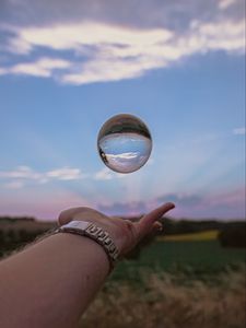 Preview wallpaper ball, hand, reflection, watch, sky