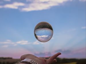 Preview wallpaper ball, hand, reflection, watch, sky