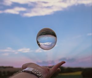 Preview wallpaper ball, hand, reflection, watch, sky