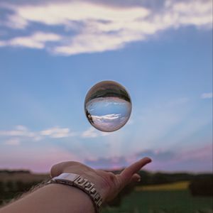 Preview wallpaper ball, hand, reflection, watch, sky