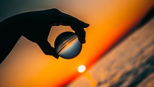 Preview wallpaper ball, hand, sunset