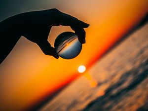 Preview wallpaper ball, hand, sunset