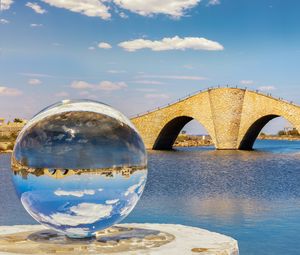 Preview wallpaper ball, river, bridge, clouds, reflection