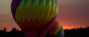 Preview wallpaper balloons, colorful, trees, sunset