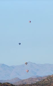 Preview wallpaper balloons, mountains, rocks, flight, sky