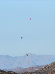 Preview wallpaper balloons, mountains, rocks, flight, sky