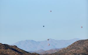 Preview wallpaper balloons, mountains, rocks, flight, sky