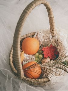 Preview wallpaper basket, fruit, leaves, feather