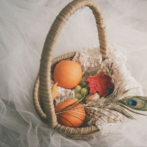 Preview wallpaper basket, fruit, leaves, feather