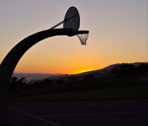 Preview wallpaper basketball hoop, mesh, basketball, sport, sunset, dark