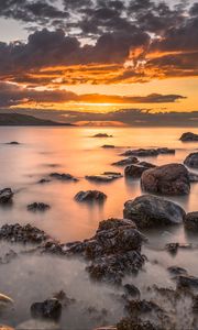 Preview wallpaper bay, sunset, horizon, stones, clouds