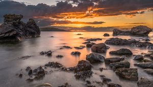 Preview wallpaper bay, sunset, horizon, stones, clouds