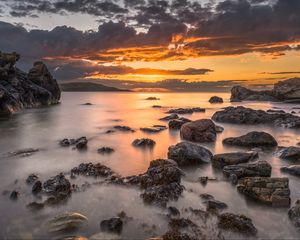 Preview wallpaper bay, sunset, horizon, stones, clouds