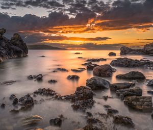 Preview wallpaper bay, sunset, horizon, stones, clouds