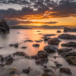 Preview wallpaper bay, sunset, horizon, stones, clouds