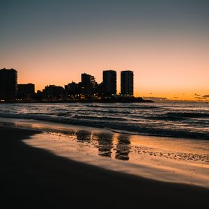 Preview wallpaper beach, city, buildings, sea, dusk, dark