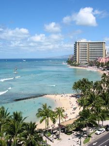 Preview wallpaper beach, city, sand, palm trees, people, coast, waves