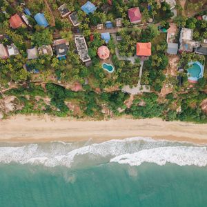 Preview wallpaper beach, coast, aerial view, buildings, palm trees