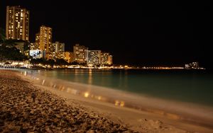 Preview wallpaper beach, coast, sand, city, fires, night, skyscrapers