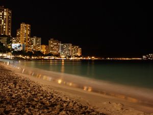 Preview wallpaper beach, coast, sand, city, fires, night, skyscrapers
