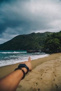 Preview wallpaper beach, hand, rocks, sea, waves