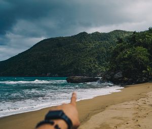Preview wallpaper beach, hand, rocks, sea, waves