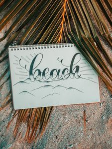 Preview wallpaper beach, notebook, palm, branch, sand, text