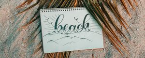 Preview wallpaper beach, notebook, palm, branch, sand, text