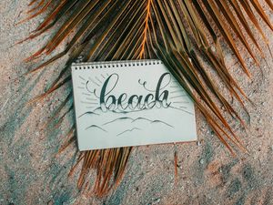 Preview wallpaper beach, notebook, palm, branch, sand, text