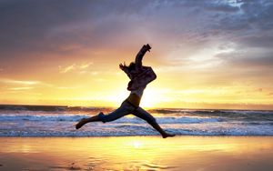 Preview wallpaper beach, people, jump, sunset, sea