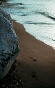 Preview wallpaper beach, rocks, sand, footprints