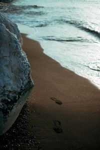 Preview wallpaper beach, rocks, sand, footprints