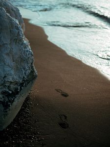 Preview wallpaper beach, rocks, sand, footprints