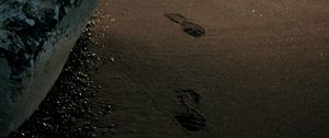 Preview wallpaper beach, rocks, sand, footprints