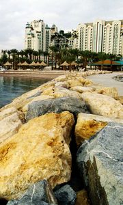 Preview wallpaper beach, rocks, water, homes, resort