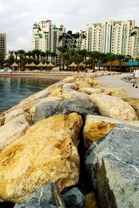 Preview wallpaper beach, rocks, water, homes, resort