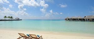 Preview wallpaper beach, sand, chairs, resort, sky, clouds, bungalow, huts, blue, clearly, horizon, relax