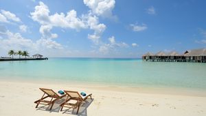 Preview wallpaper beach, sand, chairs, resort, sky, clouds, bungalow, huts, blue, clearly, horizon, relax