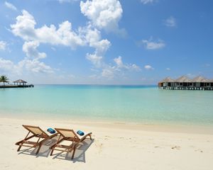 Preview wallpaper beach, sand, chairs, resort, sky, clouds, bungalow, huts, blue, clearly, horizon, relax