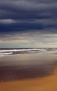 Preview wallpaper beach, sand, coast, ocean, person, loneliness, cloudy, emptiness