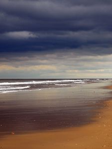 Preview wallpaper beach, sand, coast, ocean, person, loneliness, cloudy, emptiness