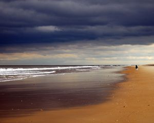 Preview wallpaper beach, sand, coast, ocean, person, loneliness, cloudy, emptiness