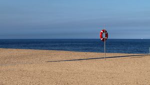 Preview wallpaper beach, sea, sand, lifebuoy, sky