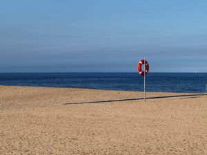 Preview wallpaper beach, sea, sand, lifebuoy, sky