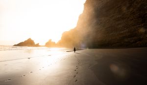 Preview wallpaper beach, silhouette, rocks, coast, sunlight